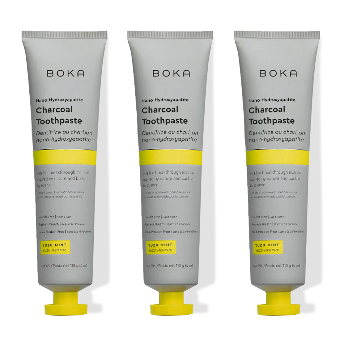 Three tubes of Boka Charcoal Toothpaste with yellow accents on a white background