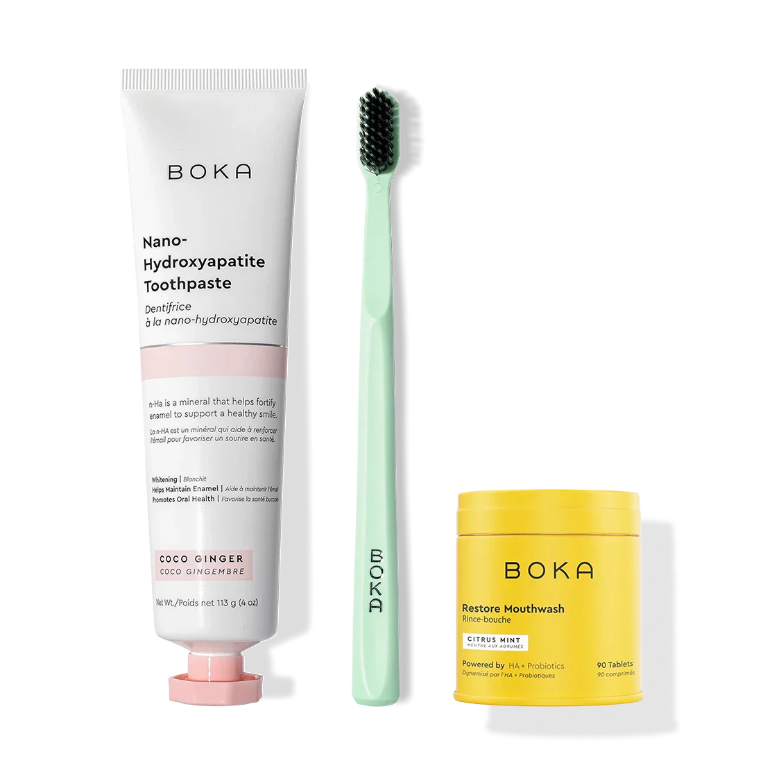 Fresh Faced toothpaste, green toothbrush with charcoal bristles, and yellow Restore Mouthwash.