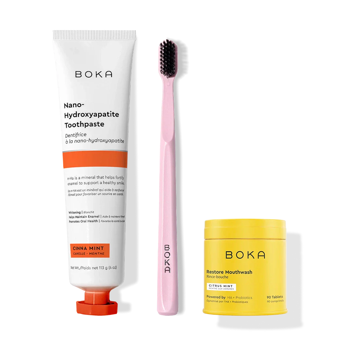 Fresh Faced toothpaste, pink toothbrush with charcoal bristles, and yellow Restore Mouthwash.