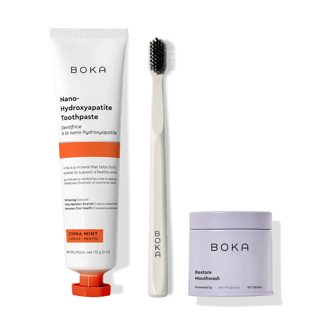Fresh Faced toothpaste, charcoal toothbrush, and Restore mouthwash on a white background.