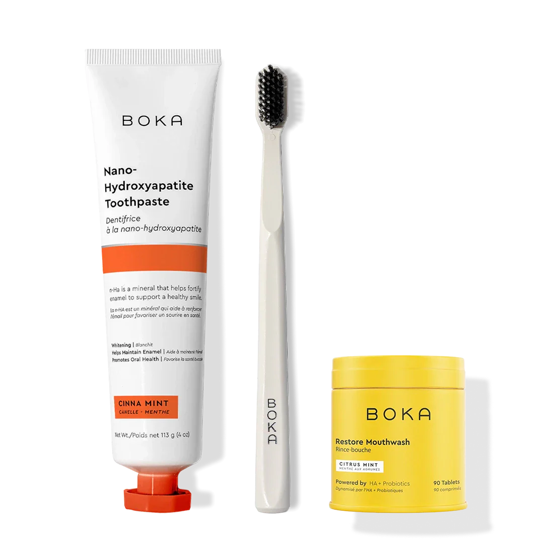 Fresh Faced Toothpaste, toothbrush with activated charcoal bristles, and yellow Restore Mouthwash tablets.