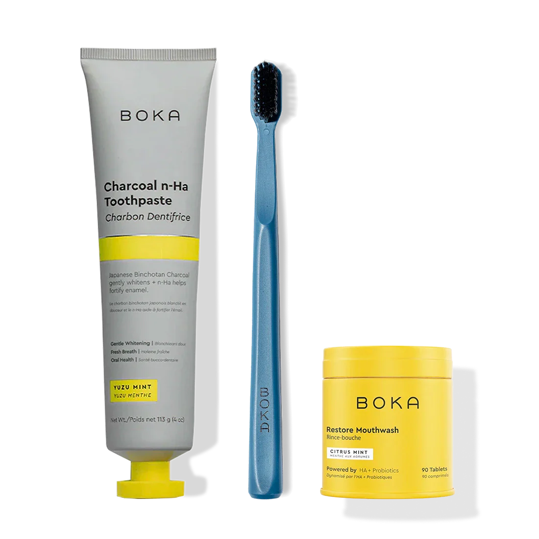Fresh Faced toothpaste, blue charcoal-bristle toothbrush, and yellow restore mouthwash tablets.