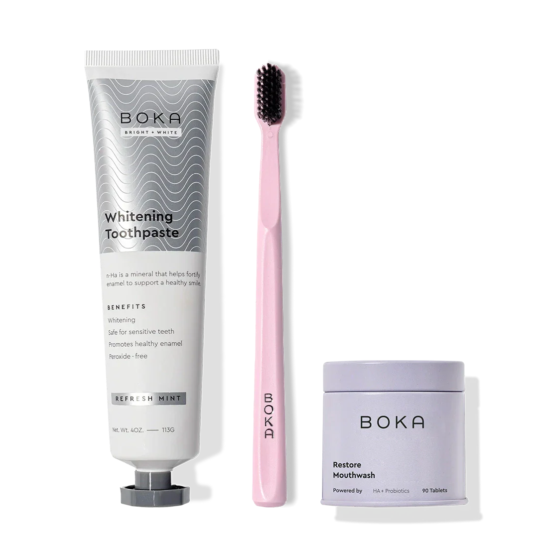 Fresh Faced Toothpaste, pink toothbrush with charcoal bristles, and mouthwash tabs on white.