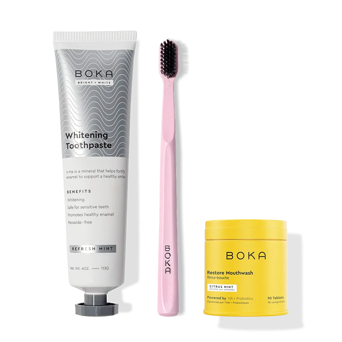 Fresh Faced toothpaste, a pink toothbrush with charcoal bristles, and yellow Restore tablets.