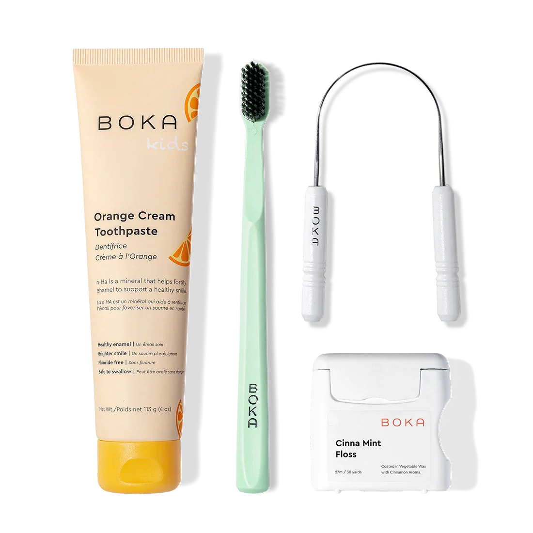 Starter Kit: toothpaste, green charcoal toothbrush, tongue cleaner & Cinna Mint floss on white.