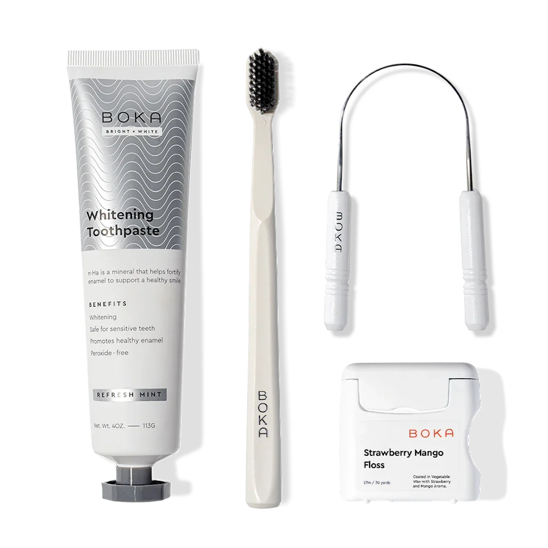 Starter Kit with nano-hydroxyapatite toothpaste, toothbrush, floss & dental tool on white.