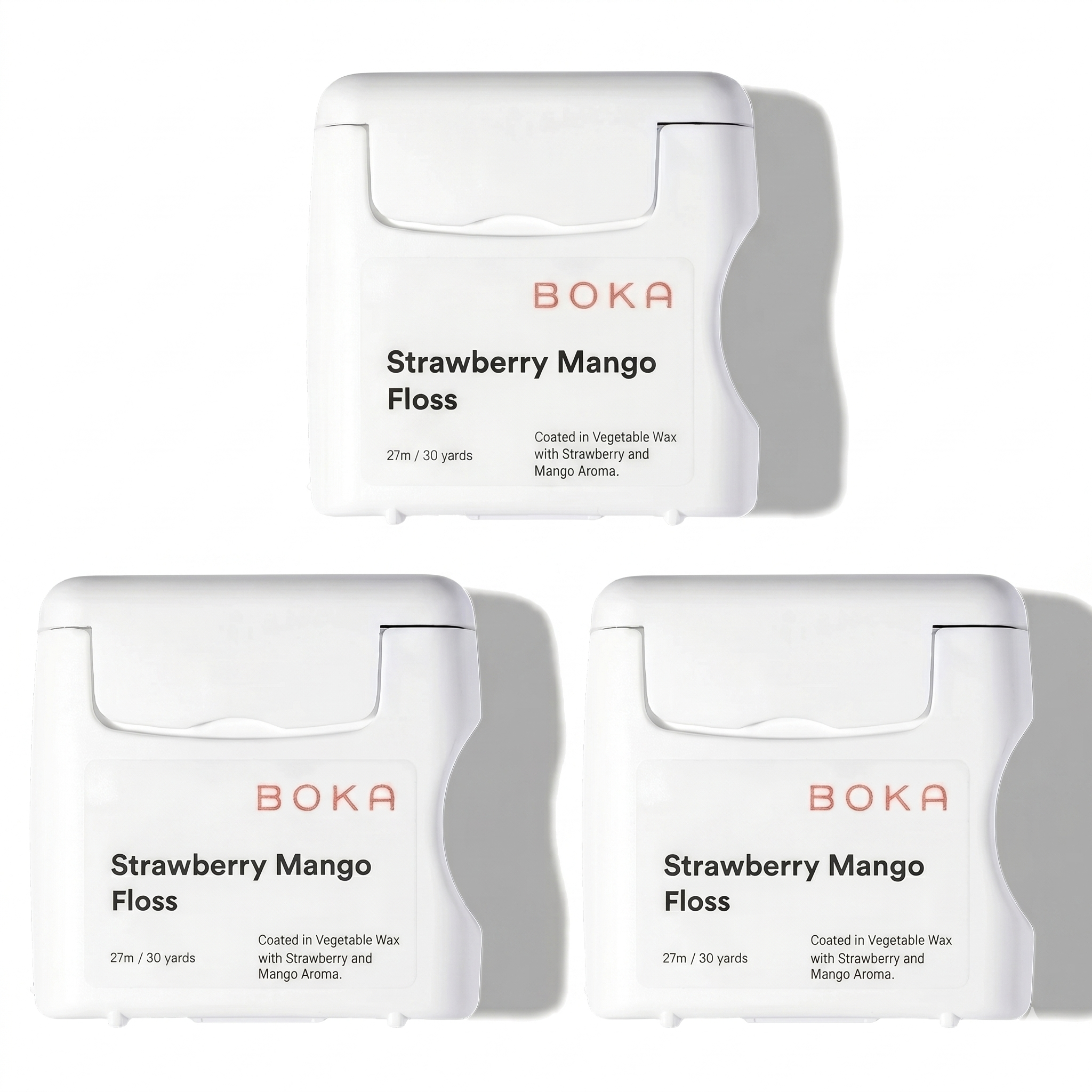 Three packages of Boka Strawberry Mango Floss on a white background
